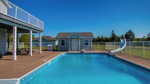 A swimming pool with a slide, a covered patio, and a small building in the background. - A FRAME ALPHA -WoW This Old Tree
 (Five Islands)