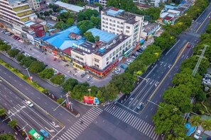 An aerial view of a city intersection with buildings, roads, and greenery. - Boutique Holiday Hotel (Beihai Beibuwan Square) (Beihai)