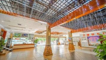 A spacious indoor area with a high ceiling, columns, and a large open space.