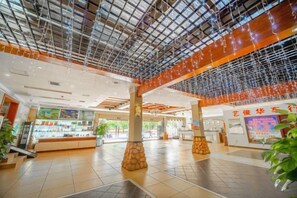A spacious indoor area with a high ceiling, columns, and a large open space. - Boutique Holiday Hotel (Beihai Beibuwan Square) (Beihai)