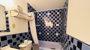 A bathroom with a bathtub, toilet, sink, and a towel rack. - Dew Drop Inn Motel by OYO Miller SD (Miller)
