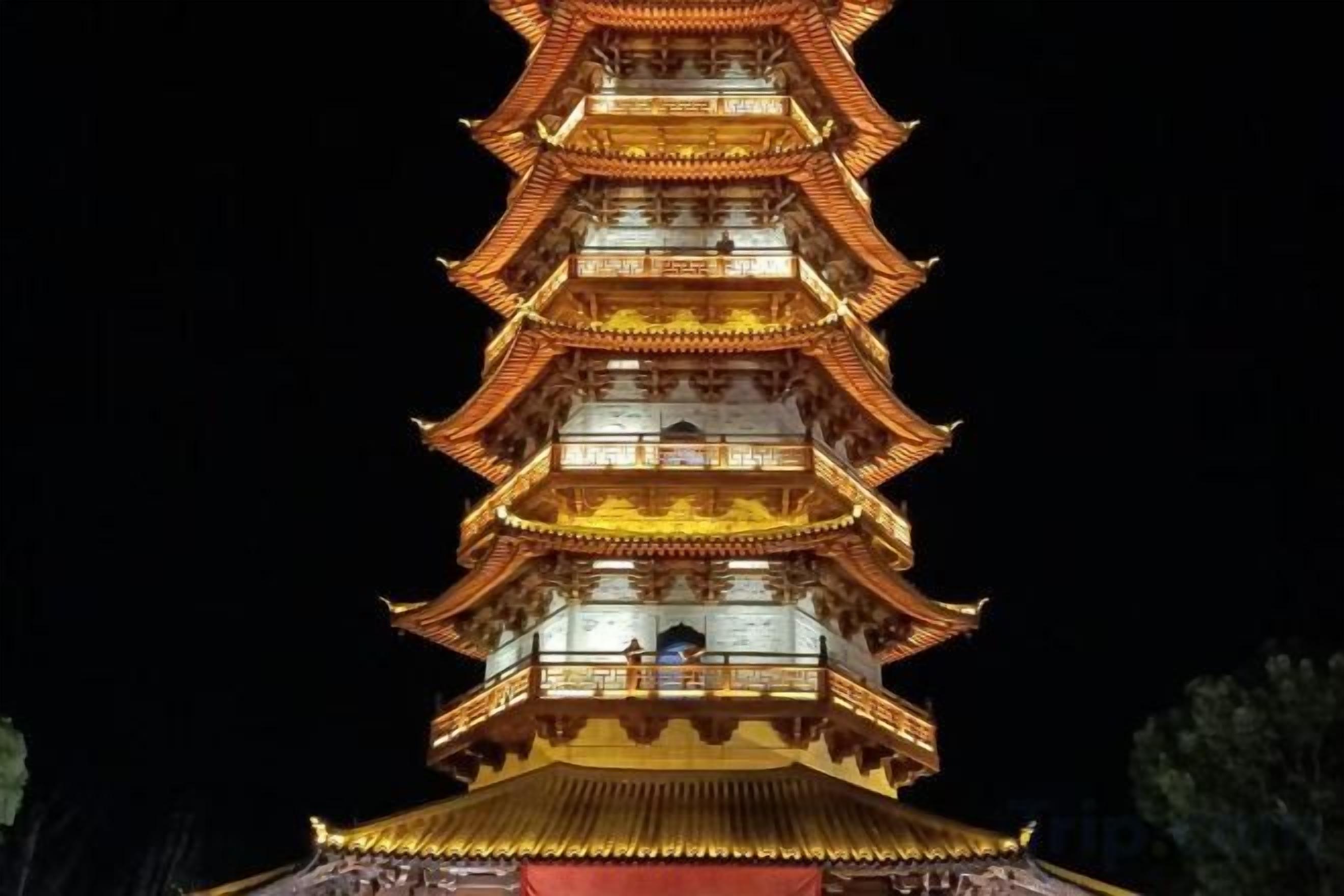 A multi-tiered pagoda-style building with illuminated tiers and a traditional roof.