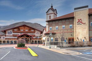 A building with a prominent tower, a sign for 'Steak & Chop Haus,' and a parking lot with marked handicapped spaces.