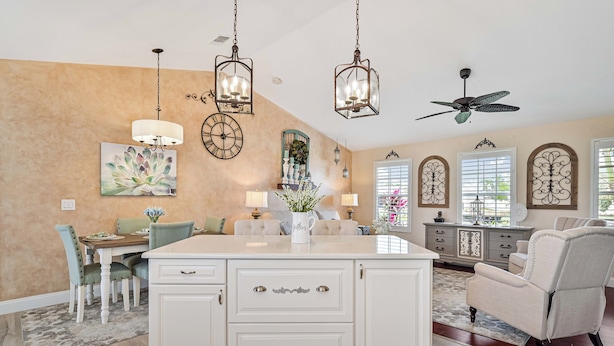 A spacious kitchen with a central island, pendant lighting, and a ceiling fan. - Heated Pool/cozy/highly recomended/premier host/Elegant/close to many activities (Cape Coral)