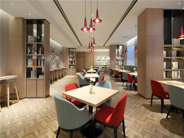 A modern dining area with multiple tables and chairs, bookshelves, and pendant lighting. - Borrman Hotel (Shanghai)