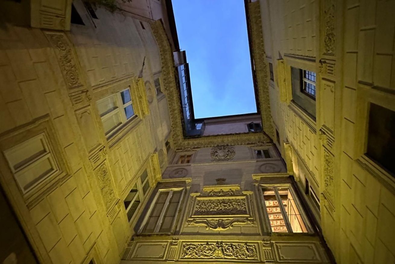 An architectural view of a building with ornate facades and a skylight.