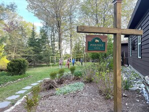 Property grounds - Updated cabin sleeps 8. Pet friendly, and has private neighborhood beach. (Charlevoix)