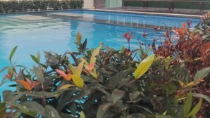A multi-story building with a swimming pool in the foreground. - Condo 604, w/ Pool & Gym & Minutes to Baguio city Attractions (2600 Baguio City)