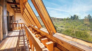A wooden balcony with a view of a hilly landscape. - Sundance Ranch Retreat | Hot Tub • Cascade Views (Deschutes County)
