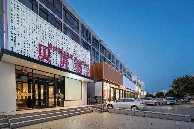 A hotel with a modern facade, large windows, and a visible entrance.