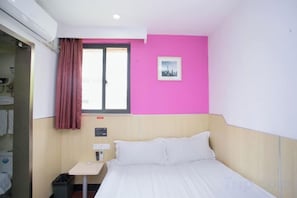 A hotel room with a bed, a small table, a window with curtains, and a picture on the wall. - 100 Inn (Shanghai Jiangpu Road Metro Station) (Shanghai)