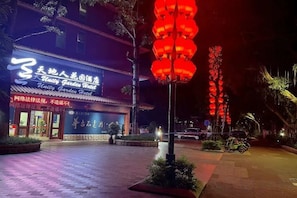 A building with a sign that reads 'Nitty Gritty Garden World' at night.