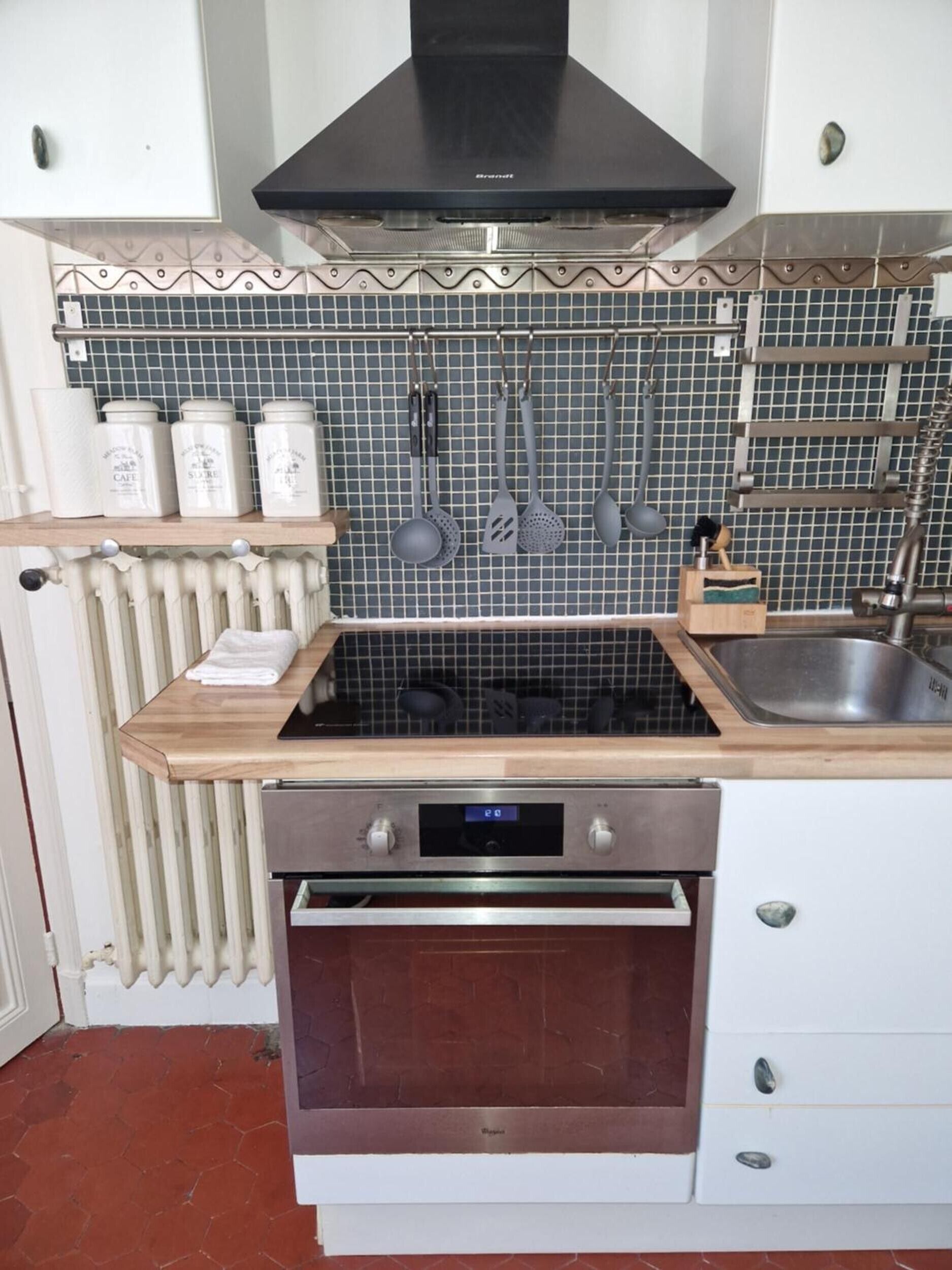 A kitchen with a stove, oven, and a tiled backsplash.