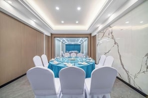 A conference room with a round table, white chairs, and a blue tablecloth. - Anji Meilin Resort (Anji)