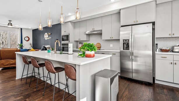 A modern kitchen with a central island, stainless steel appliances, and pendant lighting. - Cozy Haven in Hermitage (Nashville)