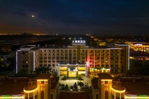 A large hotel with multiple floors, a central courtyard, and a well-lit facade. - Xinken Hotel (Guangzhou)