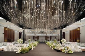 A banquet hall with rows of tables, white chairs, and floral centerpieces. - Neijiang International Hotel (Wanda E-commerce Center) (Neijiang)