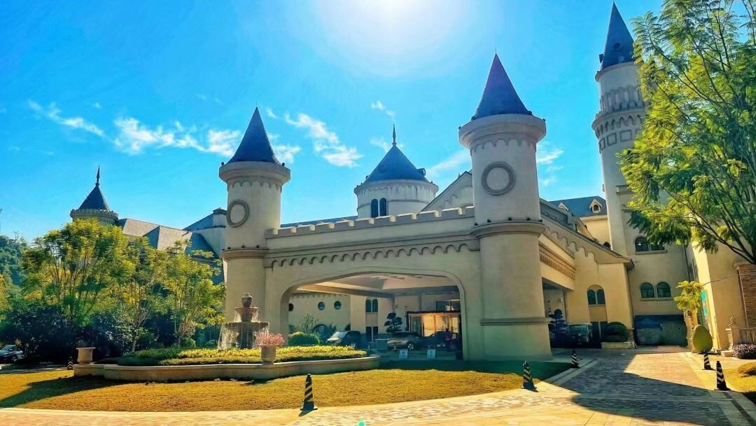 A castle-like building with multiple towers and a central archway.