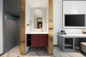 A modern bathroom with a vanity, mirror, and a television mounted on the wall. - Jingqi Ouju Hotel (Beijing Fengtai Railway Station Lize Business District) (Beijing)
