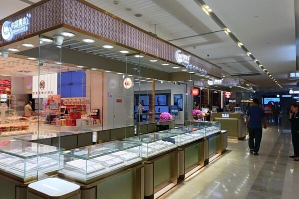 A jewelry store with glass display cases and a brick facade.