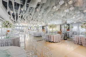 A spacious hall with multiple round tables, clear chairs, and hanging light fixtures. - Yuanzhongfang Hotel (Pingdu)