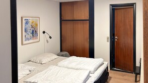 A bedroom with a bed, a bedside lamp, a door, and a wall-mounted painting. - Beautiful home in Aabenraa with WiFi (Aabenraa)