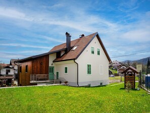 Stroll up to this charming two-story home with a front porch and beautifully manicured lawn.