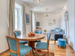 Relax in this stylish living space with a round dining table, comfortable seating, and a cozy sofa.