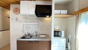 A compact kitchenette with a sink, a microwave, and a small refrigerator. There is a clock on the wall and a no-smoking sign. - N52#[NEW] Tokyo comfortable guest rooms / direct access to Akihabara and Shinjuku / 8 min walk from JR Shinkoiwa station / convenient access to Narita & Haneda Airport (江戸川区)