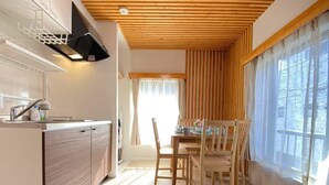 A modern kitchen with wooden cabinets, a built-in oven, and a dining area with a wooden table and chairs. - N52#[NEW] Tokyo comfortable guest rooms / direct access to Akihabara and Shinjuku / 8 min walk from JR Shinkoiwa station / convenient access to Narita & Haneda Airport (江戸川区)