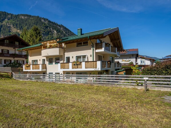Situated in a mountainous area, this chalet-style building offers a clear view of the surrounding hills.