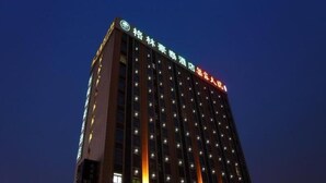 A multi-story hotel building with illuminated windows and a sign at the top. - Greentree Inn Newtown Malu Subway Station Business (Shanghai)