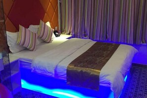 A bed with a headboard, pillows, and a blanket. - C8 Chain Hotel (Shanghai)