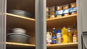 A kitchen with a microwave, toaster, and various food items on shelves. - North End Relaxing Family (Manchester)
