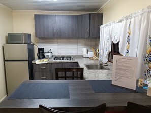 Fridge, microwave, stovetop, coffee/tea maker