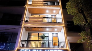 A hotel named Celina Hotel with a modern facade, multiple balconies, and illuminated signage. - CELINA HOTLE Ninh Bình (Hoa Lu)
