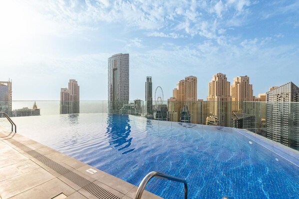 A rooftop infinity pool with a city skyline view.
