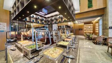 A buffet area with multiple food stations and seating arrangements.