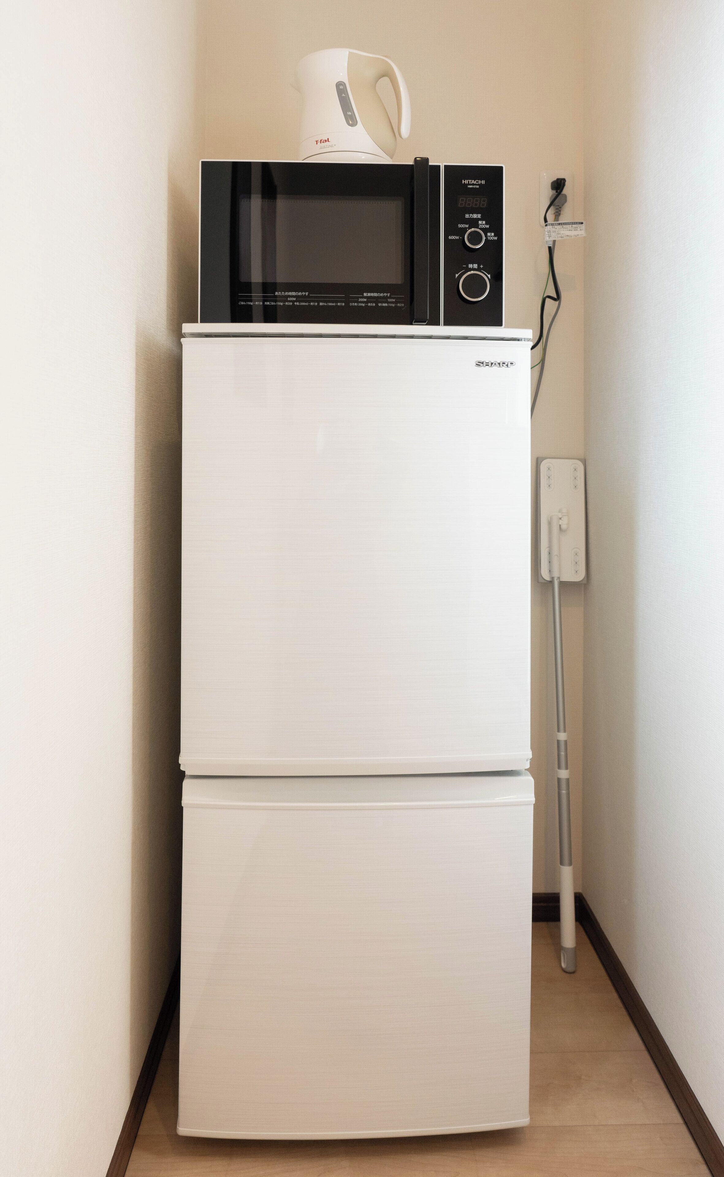 A compact kitchenette with a microwave and a refrigerator.
