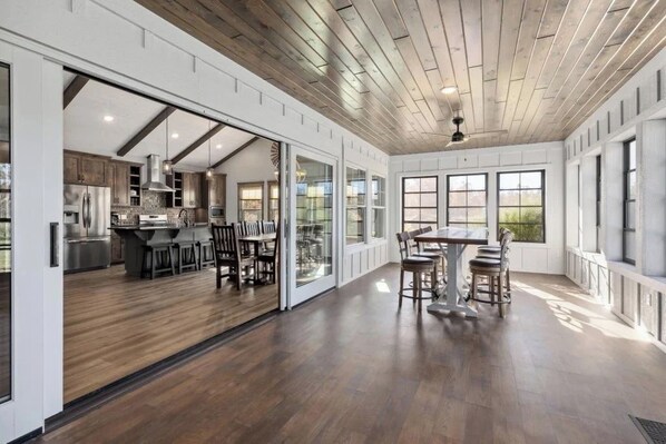 A spacious kitchen with modern appliances and a dining area with a large table and chairs.