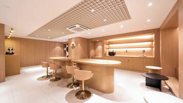 Relax in our stylish lobby with a central bar, reception desk, and cozy seating area.
