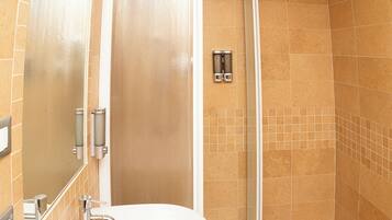 A bathroom with a shower, a sink, and a mirror.