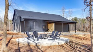 A modern building with a large open patio area featuring outdoor seating. - Pet-Friendly Yard! Nature Escape in Forest City (Forest City)