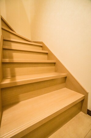 A wooden staircase with multiple steps leading upwards. - HANASTAY ARASHI (Osaka)