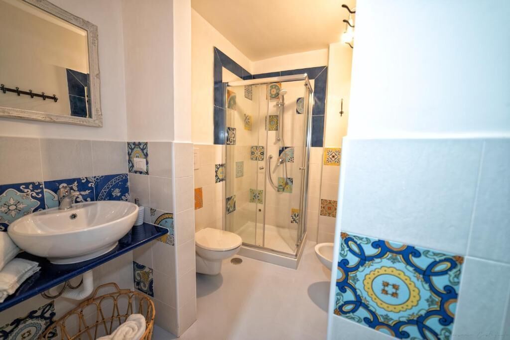 A bathroom with a sink, toilet, and shower.