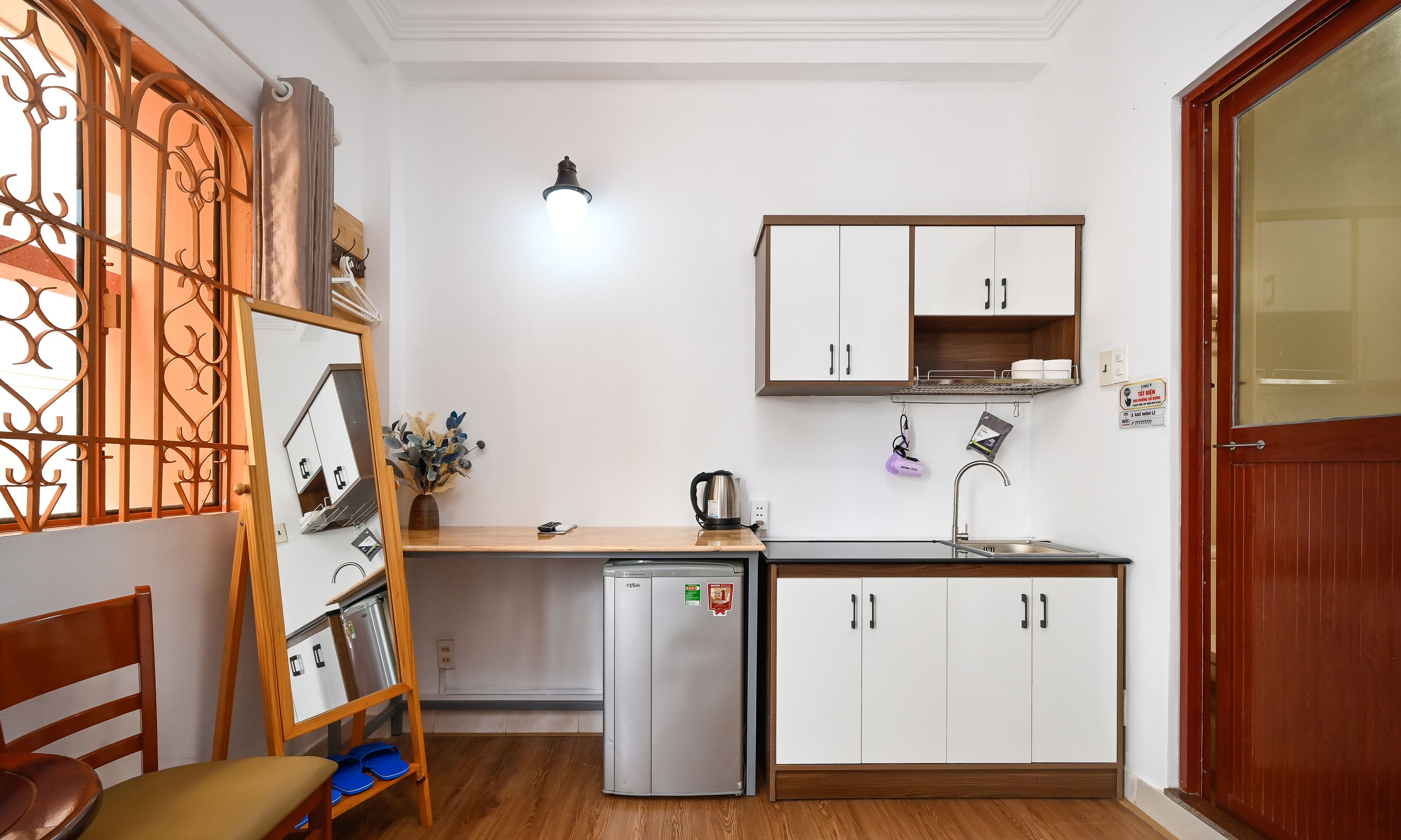 A compact kitchen with a refrigerator, a sink, and a small countertop.