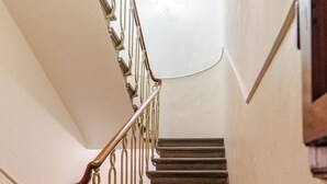 A staircase with wooden handrails and a light fixture at the top. - Elegant & Cozy Apartment Florence City Center (Firenze)