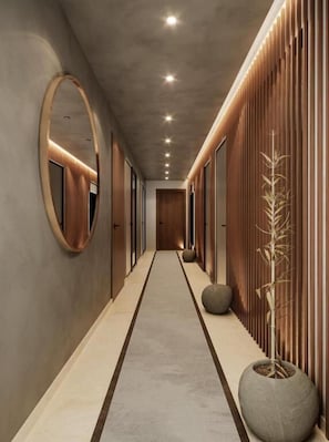 A modern hallway with a central lighted path, wooden paneling on the right, and a round mirror on the left. - Citadines Almaz Casablanca (Casablanca)