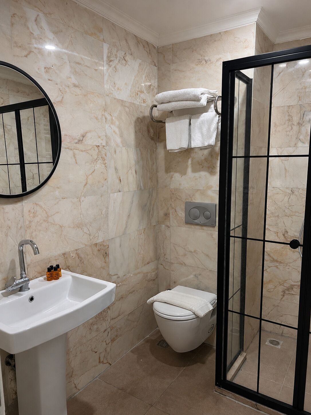 A bathroom with a sink, toilet, and shower.