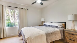 A bedroom with a bed, a nightstand, a lamp, a ceiling fan, and a window with curtains. - Updated Home w/ Private Deck, 1 Mi to Rose Bowl! (Pasadena)